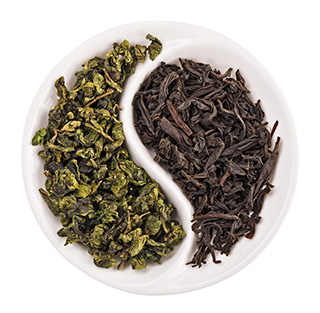 bowl with half dried green tea leaves and the other half dried black tea leaves