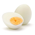Boiled egg with a boiled egg infront showing half cut yolk and whites