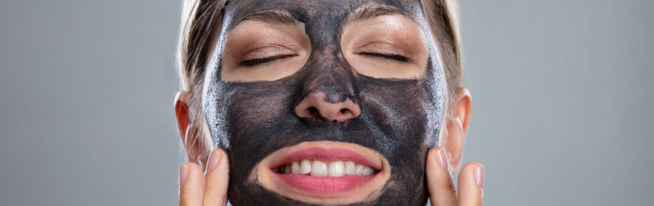 woman with activated charcoal face mask to show benefits to skin