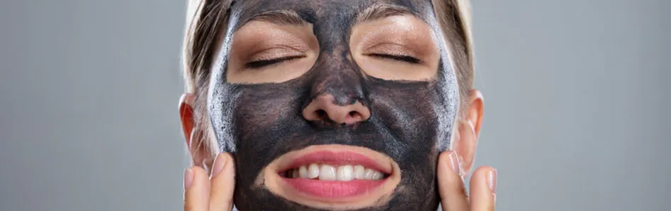 woman with activated charcoal face mask to show benefits to skin