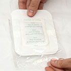 image of woman removing footpad from plastic packaging