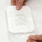 image of woman removing footpad from plastic packaging