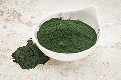 image of a bowl with ground green magic powder and next to it