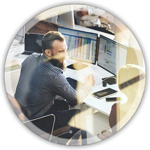 circle img 2 man sitting at a desk working on a computer with multiple screens