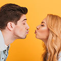 man and woman about to kiss withough touchinng to stop spread of germs