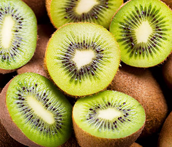 kiwis next to each other with half cut kiwis on top