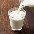 Image Of Milk Pouring into a Glass to show benefits Image Of Milk Pouring into a Glass to show benefits