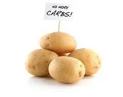 photograph of potatoes with a no more carbs sign on them