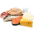 Selection of raw meat for example beef fish chicken and a glass of milk and cheese Selection of raw meat for example beef fish chicken and a glass of milk and cheese