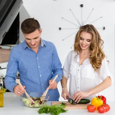 man and woman preparing a salad to show how to balance metabolism