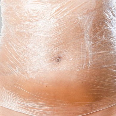 image of womans stomach wrapped in cling film to show bdy wraps
