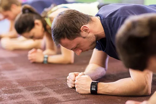 photograph of men and women doing the plank exercise number 4