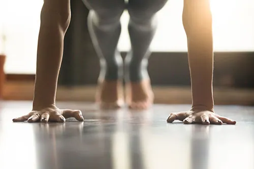 woman doing a press up which is exercise number one