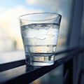 glass of water to show what to drink to prevent illness