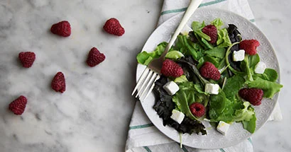Plate of raspberry and feta salad with a fork