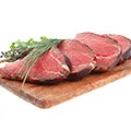 four steaks on a chopping board that have been seasoned to show that its good for muscle development