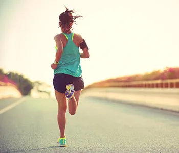 woman running on a road with running clothes to encourage you to start exercise