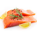 two fillets of salmon garnished with two slices lemon, rich in omega 3 and protein