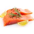two fillets of salmon garnished with two slices lemon, rich in omega 3 and protein