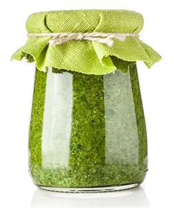 glass jar of spirulina extract in it covered with cloth and elastic band