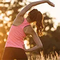 woman dressed in running clothes stretching to show it aids recovery