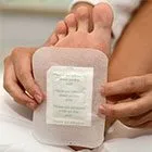 image of woman placing a footpad on the sole of her foot