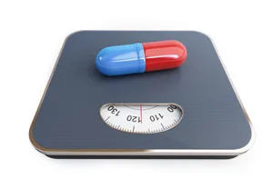 photograph of a weighting scale with a capsule on it