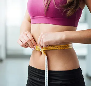 Woman Measuring Her Waist Size